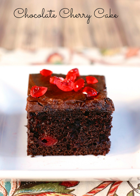 Chocolate Cherry Cake - doctored up cake mix with cherry pie filling and almond extract. Topped with a quick homemade chocolate frosting. This cake is requested for birthday's and potlucks! SO good!