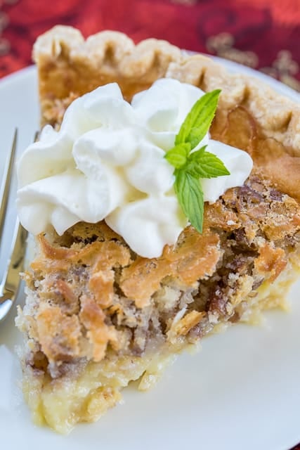 Coconut Pecan Chess Pie recipe -  two favorites in one dessert! Quick and delicious homemade chess pie loaded with coconut and pecans! Pie crust, sugar, eggs, butter, buttermilk, cornmeal, coconut extract, coconut, pecans. Can make ahead of time and refrigerate until ready to serve. Top with fresh homemade whipped cream. SO good! A MUST for your holiday meal!! #pie #dessert #dessertrecipe