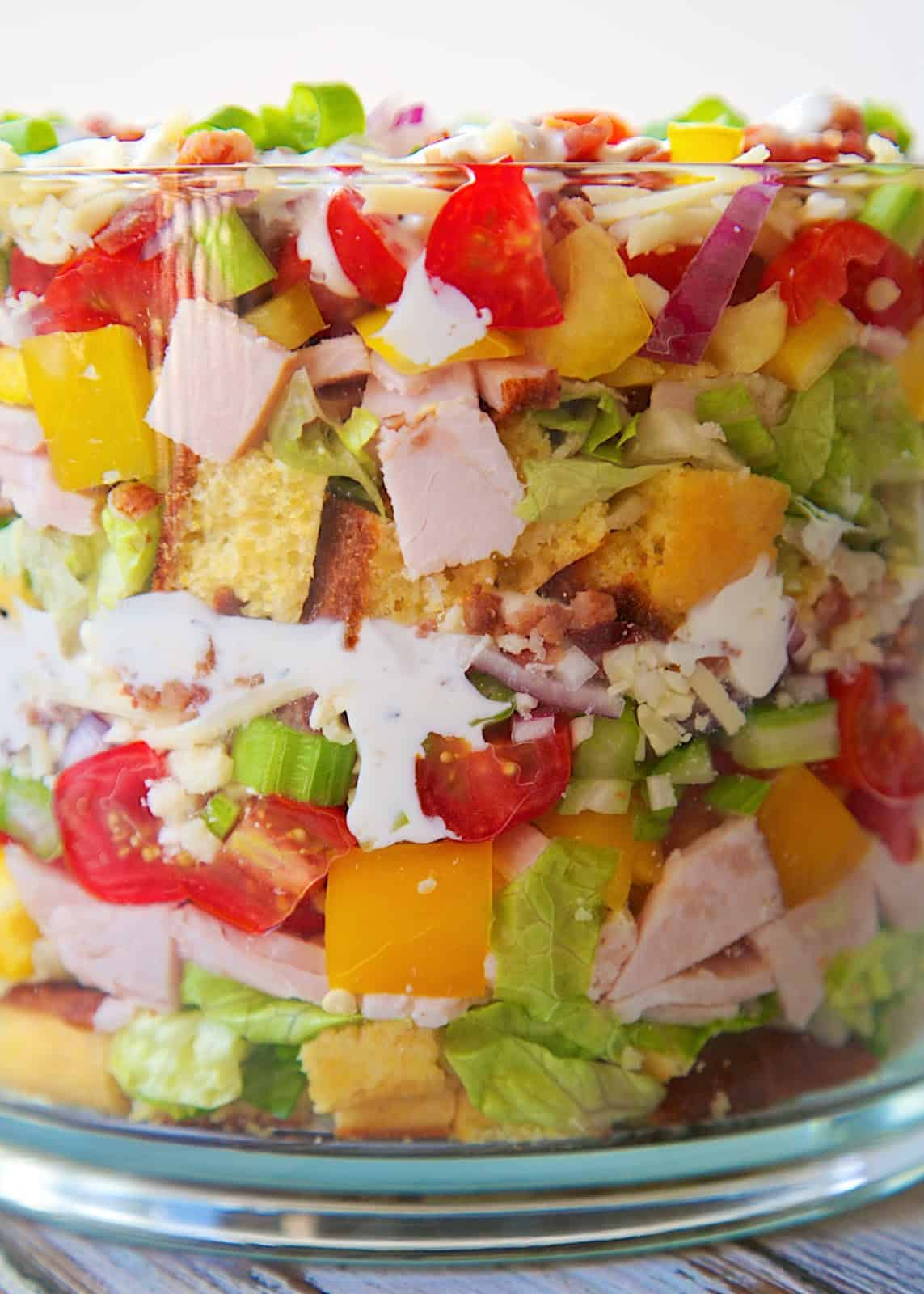 Cornbread & Turkey Layered Salad Recipe - loaded with cornbread, turkey, cheese, vegetables and bacon! It is a whole meal in one big bowl! Make ahead of time and refrigerate before serving. Can be made 24 hours in advance. Perfect for brunch/lunch.