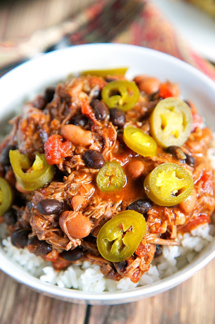 {Slow Cooker} Cowboy Pot Roast recipe - pot roast slow cooked with pinto beans, Rotel tomatoes, black beans and chili powder. SO good! Serve over rice and top with pickled jalapeños. Also makes a great freezer meal! 