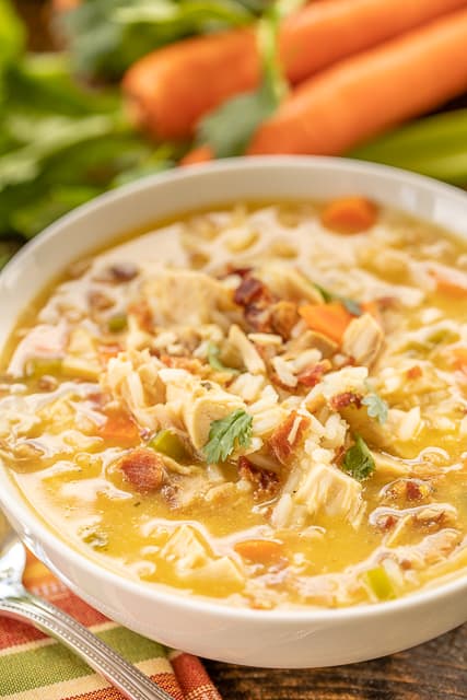 Crack Chicken and Rice Soup - this soup should come with a warning label! SO GOOD!!! Ready in 30 minutes! Chicken, cheese soup, chicken broth, celery, carrots, ranch mix, bacon, and rice. Everyone went back for seconds - even our super picky eaters! A great kid-friendly dinner!! We love this soup! #soup #bacon #chickenandricesoup #crackchicken