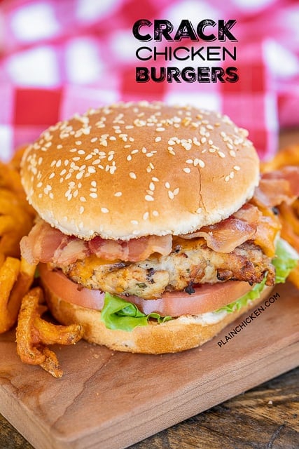 chicken burger on bun with bacon, lettuce and tomato with fries