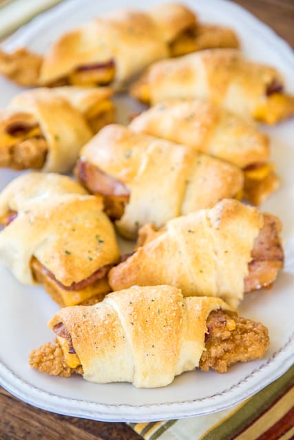 Crack Chicken Crescents - frozen chicken tenders, cheddar cheese, bacon and ranch dressing wrapped in refrigerated crescent rolls and baked. CRAZY good!!! Everyone cleaned their plate and went back for seconds! A HUGE hit with the entire family! Great for a quick lunch, dinner or tailgating! No prep work and ready to eat in under 30 minutes! YUM!