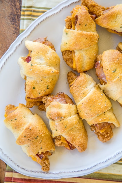 Crack Chicken Crescents - frozen chicken tenders, cheddar cheese, bacon and ranch dressing wrapped in refrigerated crescent rolls and baked. CRAZY good!!! Everyone cleaned their plate and went back for seconds! A HUGE hit with the entire family! Great for a quick lunch, dinner or tailgating! No prep work and ready to eat in under 30 minutes! YUM! #quick #easy #weeknightmeal
