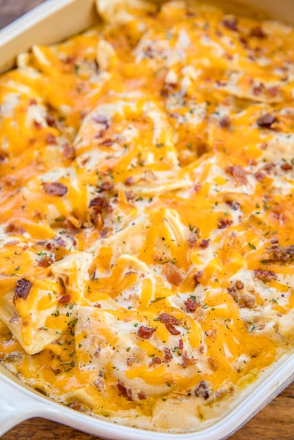 Crack Chicken Pierogi Casserole - CRAZY good!! Frozen pierogies tossed in alfredo sauce, ranch dressing mix, bacon, cheddar and chicken. Can make ahead and refrigerate or freeze for later. Everybody cleaned their plate and asked for seconds!! Weeknight dinner success!! #casserole #chicken #chickencasserole #bacon