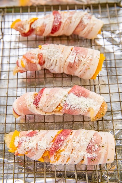 Crack Chicken Tenders - CRAZY good!! Chicken tenders seasoned with ranch, topped with cheese and wrapped in bacon. SO easy and SOOO delicious!!! Great for a quick lunch or dinner or tailgating! Dip in additional ranch dressing. I always have to double the recipe! This easy chicken recipe doesn't last long! #chicken #bacon #cheese #chickenrecipe #bakedchicken