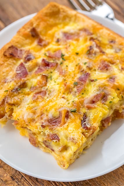 Crack Breakfast Casserole - crazy good! We are totally addicted to this easy breakfast casserole!! Crescent rolls, bacon, cheddar, ranch dressing, eggs and milk. Can make ahead of time and refrigerate overnight. SO good. We made this two days in a row! #breakfast #casserole #bacon #cheddar #breakfastrecipe