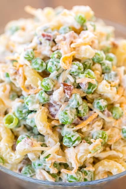 Cracked Out Pea Salad - Macaroni and green peas tossed in mayonnaise, cheddar, bacon and ranch. Seriously delicious!!! Great for potlucks or a side dish with a sandwiches. Great for all your spring and summer cookouts! Can make ahead and refrigerate until ready to serve. It has become our favorite pasta salad recipe!! #pastasalad #sidedish #bacon #ranch