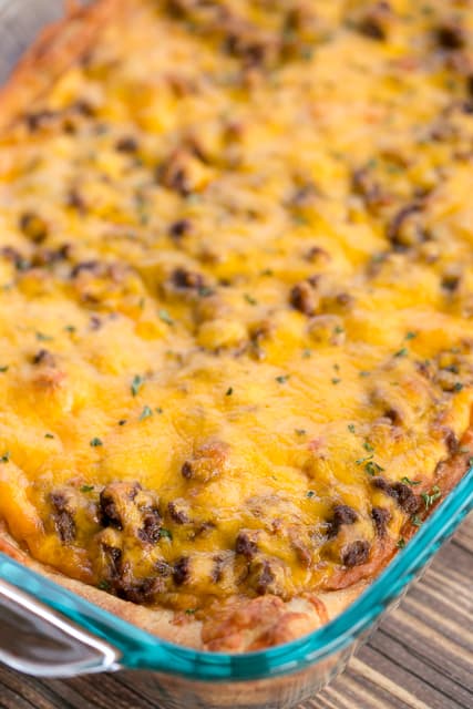 Deep Dish Taco Pizza - seriously delicious!! A fun twist to taco night. Refrigerated pizza crust topped with refried beans, taco sauce, taco hamburger meat and cheese. Top pizza with your favorite taco toppings!! Everyone loved this pizza and asked to have it again this week! Such an easy weeknight dinner recipe! Pizza plus Tacos equals HEAVEN!!!