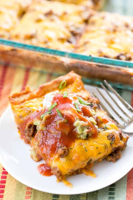 Deep Dish Taco Pizza - seriously delicious!! A fun twist to taco night. Refrigerated pizza crust topped with refried beans, taco sauce, taco hamburger meat and cheese. Top pizza with your favorite taco toppings!! Everyone loved this pizza and asked to have it again this week! Such an easy weeknight dinner recipe! Pizza plus Tacos equals HEAVEN!!!