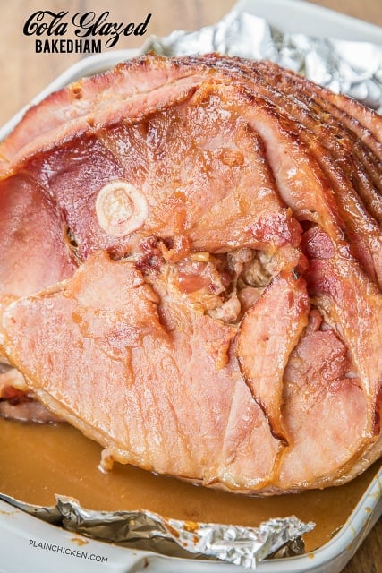Cola Glazed Baked Ham - you'll never buy a fancy store-bought honey glazed ham again! Only 3 ingredients in the glaze - brown sugar, dijon mustard and cola. Baste the ham as it bakes to get maximum flavor. Don't forget to baste in-between the slices. This ham is always a hit! It is 1000% better than that fancy store bought ham. YUM! #ham #hamrecipe #bakedham #holidayham #christmasham