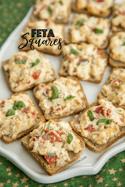 Feta Squares - perfect party food!!! Feta, cream cheese, greek seasoning, tomatoes and basil baked on top of party rye bread. This is one of my most requested party foods!! SO easy and they taste great hot out of the oven or warmed to room temperature. Great for parties and tailgating!! #feta #partyfood #appetizers 