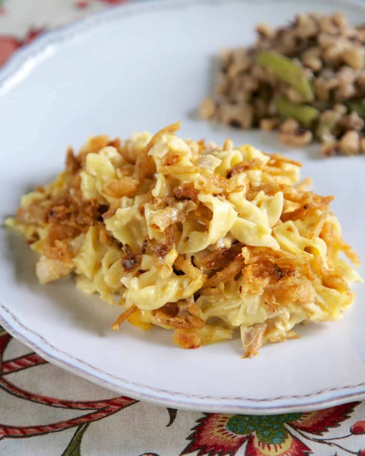 French Onion Chicken Noodle Casserole Recipe - egg noodles, french onion dip, cream of chicken soup, cheese, chicken topped with French fried onions - LOVE this casserole! Can make ahead and freezer for later. You can even split it between two foil pans - one for now and one for the freezer. Super easy main dish with only 6 ingredients that tastes great! Everyone RAVES about this casserole!