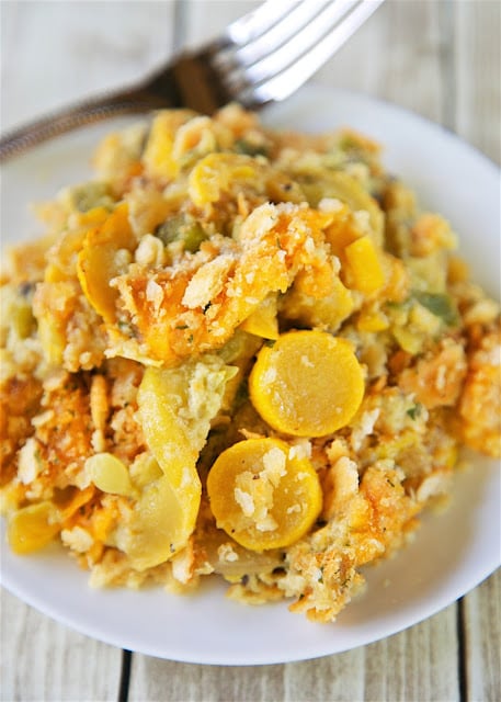 The Ultimate Squash Casserole - squash, bell pepper, onion, cream of mushroom soup, cheddar cheese, eggs, chicken base topped with Ritz crackers and butter. Even squash haters will love this casserole! SO easy and SO delicious. Took this to a potluck and everyone asked for the recipe!
