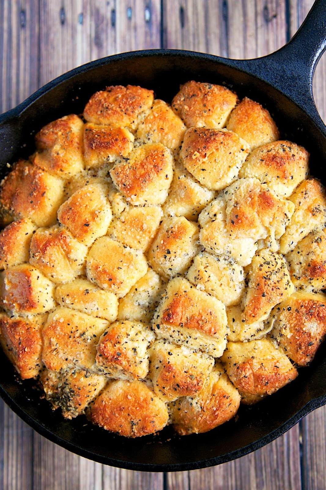 Garlic Parmesan Skillet Bread - refrigerated biscuits chopped and tossed in butter, garlic, italian seasoning and parmesan cheese. Baked in a small iron skillet. Great with pasta. Can also use as an appetizer with some warm pizza sauce. YUM!! I can make a meal out of this yummy bread!