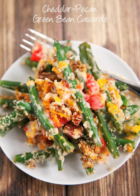 Cheddar-Pecan Green Bean Casserole - no cream of anything soup!! Fresh green beans and roasted red peppers tossed in a yummy buttermilk ranch sauce and topped with cheddar, pecans, and french fried onions. Not your grandmother's green bean casserole. This casserole is to-die-for! Can make the buttermilk ranch sauce and blanch green beans ahead of time for easy holiday meal prep!