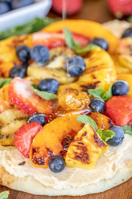 drizzling grilled fruit pizza with honey
