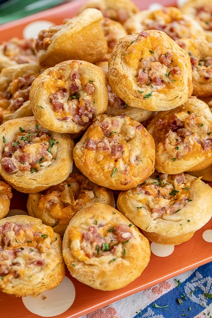 Ham & Cheese Biscuit Bites - OMG! Seriously delicious!! Great for parties and tailgating! Ham, cheddar, swiss, cream cheese, dijon mustard, Worcestershire, brown sugar mixed together and baked in biscuits. I am totally addicted to these! I could not stop eating them! I am already planning on making them again this week! #appetizer #ham #partyfood #tailgating