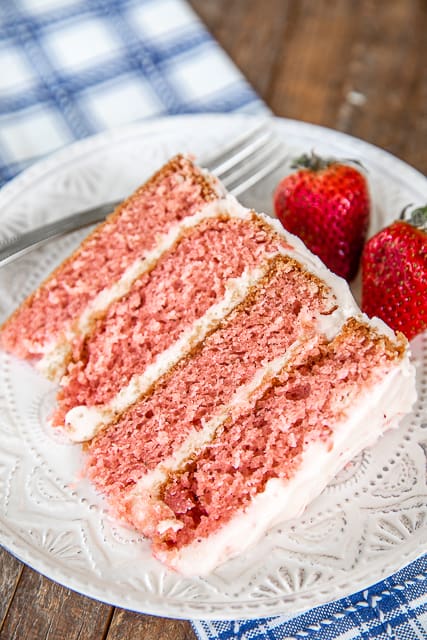 slice of strawberry layer cake on a plate