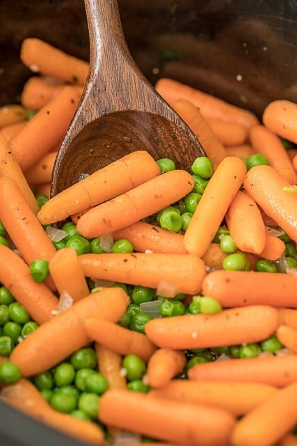 Slow Cooker Honey Glazed Peas and Carrots - easy and delicious side dish! Baby carrots, honey, butter, garlic, onion, marjoram, and peas. Amazing flavor!! Great side dish for your holiday meal! #slowcooker #sidedish #vegetables