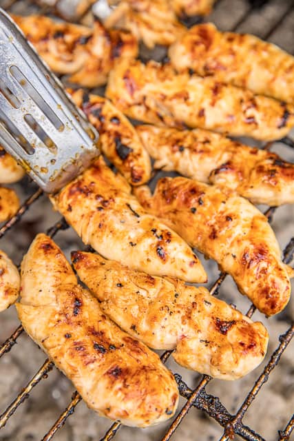 Honey Pineapple Grilled Chicken - crazy delicious!! SO simple and packed full of amazing flavor!! Only 3 ingredients in the marinade - Italian dressing, honey and pineapple juice. Can use chicken tenders, breasts or thighs. We always double the recipe for easy lunches during the week! We actually made it twice last week!! SO good! #chicken #grilling #chickenrecipes #grilled