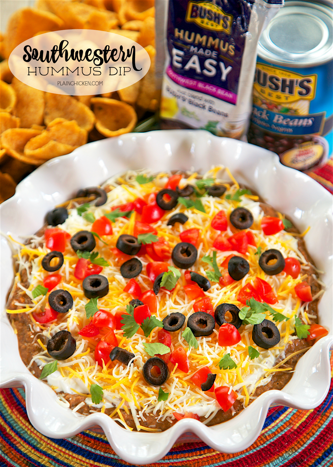 Southwestern Hummus Dip - 2 ingredient homemade black bean hummus topped with sour cream, cheese, tomatoes, olives and cilantro. Add some green chiles to the hummus for a kick! I took this to a party and everyone loved it. Even the hummus, black bean and sour cream haters raved about this simple dip. Ready in 5 minutes!! Can't beat that!