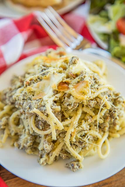Cheesy Sausage Pesto Pasta Bake - only 6 ingredients! Sausage, spaghetti, pesto, ricotta, mozzarella and parmesan - SO good! Great make ahead pasta casserole recipe - can freeze too! There are never any leftovers. Such a quick and easy casserole recipe!! #pasta #casserole