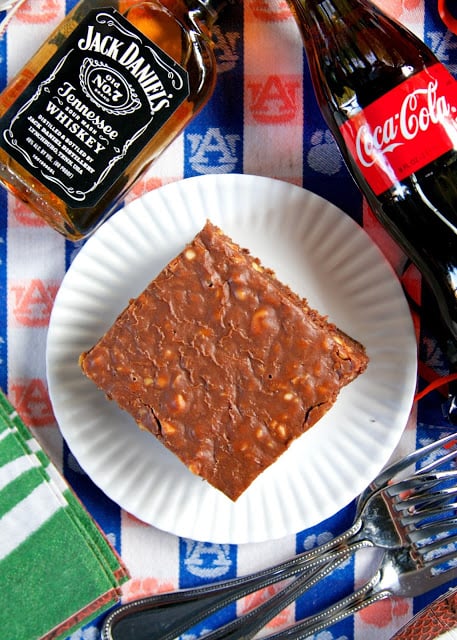 Jack and Coke Cake - our favorite drink in cake form! Homemade buttermilk chocolate cake and fudge frosting spiked with Jack Daniels. SO good! Great for a potluck and tailgate party!