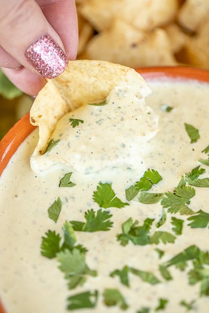 dipping a chip into jalapeno ranch dip