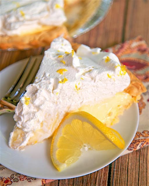 Lemon Sour Cream Pie - quick homemade lemon and sour cream filling topped with fresh whipped cream. SO light and delicious! A new favorite!! Great for potlucks and the holidays.