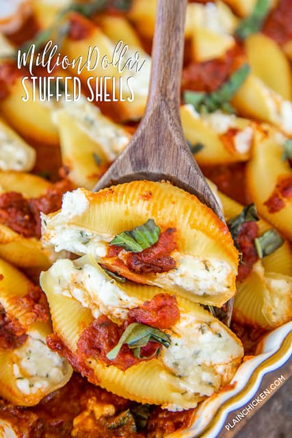scooping baked stuffed shells from baking dish