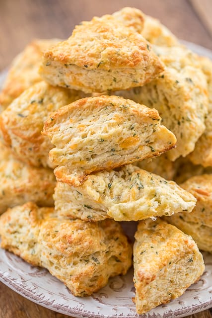 Mini Cheddar Scones - CRAZY good!!! They go with everything - soups, stews, casseroles, grilled meats. We make these yummy biscuits every week! Flour, baking soda, baking powder, salt, butter, cheese, and buttermilk. Surprisingly easy to make! We gobble these up!!
