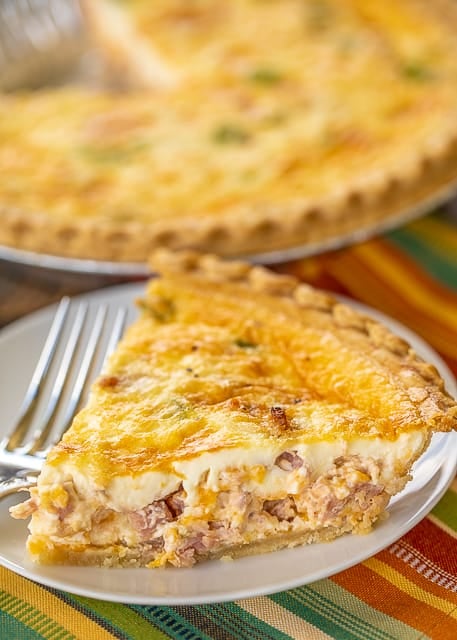 Mississippi Sin Quiche - all the flavors of our favorite dip in a quiche! Can make ahead and refrigerate or freeze for later. Ham, cream cheese, cheddar cheese, worcestershire sauce, green onion, hot sauce, sour cream, eggs, milk, pie crust. Everyone LOVED this delicious quiche!! I always double the recipe because this doesn't last long. SO good! #quiche #mississippisin #ham #breakfast #freezermeal