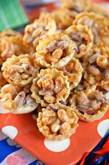  Mixed Nut Tarts - honey roasted mixed nuts tossed in a homemade caramel sauce and baked in mini phyllo shells. Ready in 15 minutes! Great for parties and your holiday table! Double the recipe - they were gone in a flash!! Can make up to 2 days in advance.
