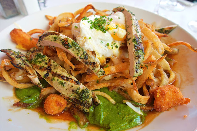 Chicken Poutine - Hand-cut fries, grilled chicken, jarlsberg cheese, fried cheese curds, parsley-arugula jus topped with a poached egg - from Mon Ami Gabi at Paris Hotel in Las Vegas.