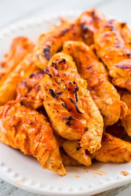 Orange Buffalo Grilled Chicken - chicken marinated in buffalo sauce and orange juice - grill, pan sear or bake for a quick weeknight meal. A little spicy, a little sweet and a whole lotta delicious! Ready to eat in 15 minutes!