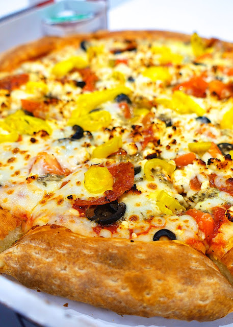 Papa John's Greek Pizza - mozzarella, basil pesto, black olives, roma tomatoes, pepperoni, feta and banana peppers