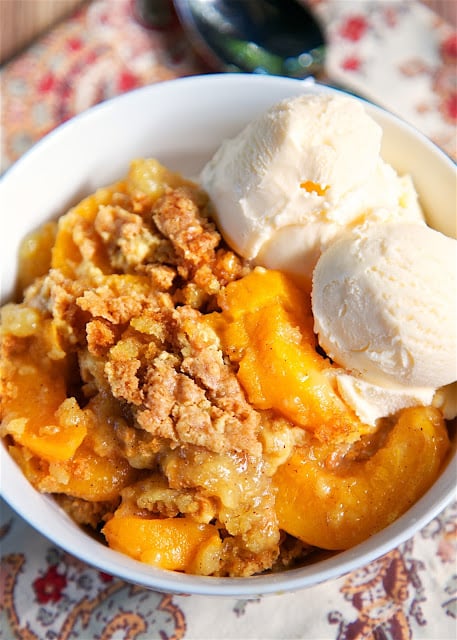 Peach Cobbler Dump Cake - only 4 ingredients for the most delicious dessert ever! LOVE this!!! Literally takes a minute to make and everyone loved it. There were no leftovers! Serve warm with some vanilla ice cream. YUM!