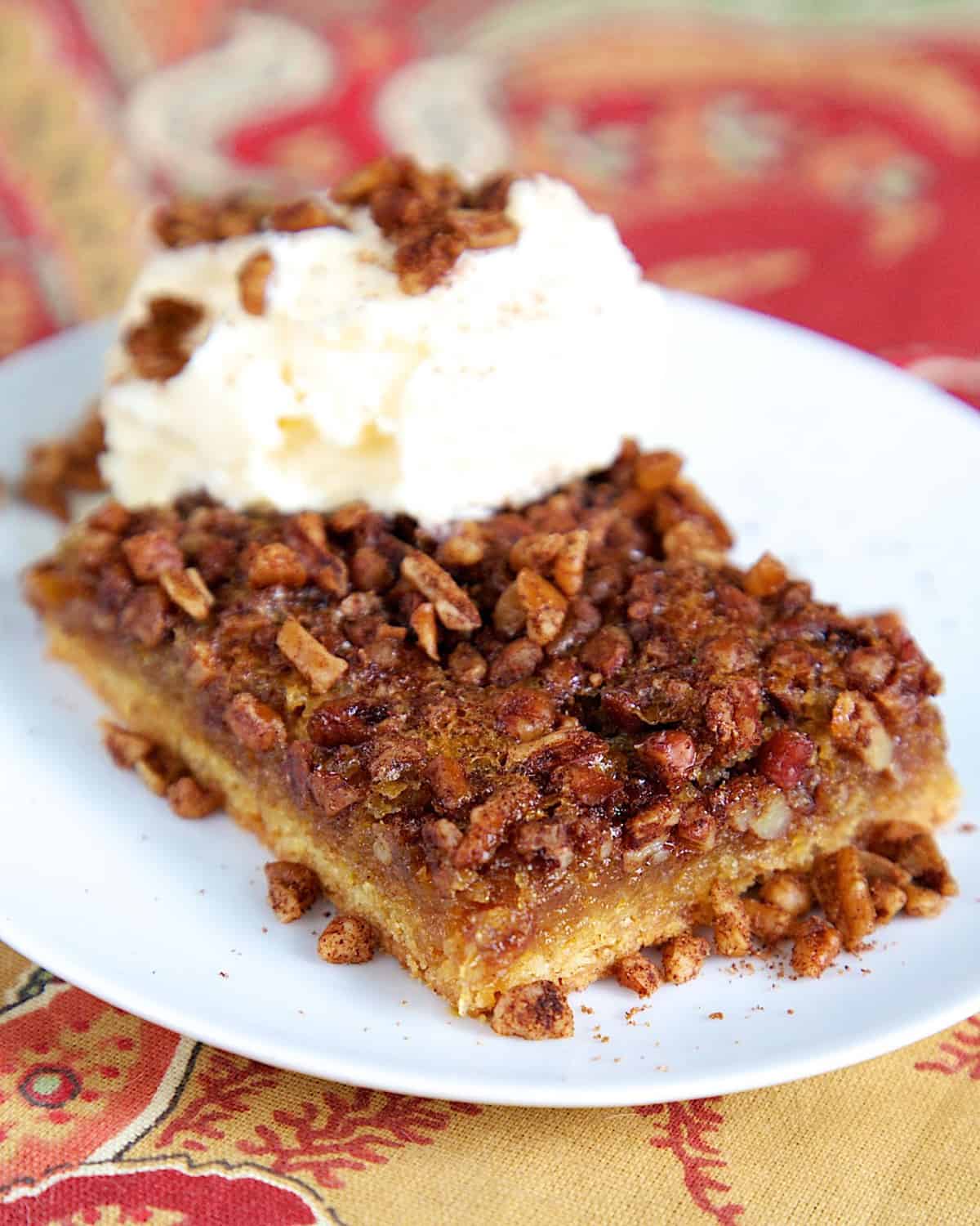 Gooey Pecan Bars - cake mix crust topped with yummy pecan pie filling. Serve warm with ice cream! Perfect for holiday meals! Everyone RAVES about this easy dessert recipe!