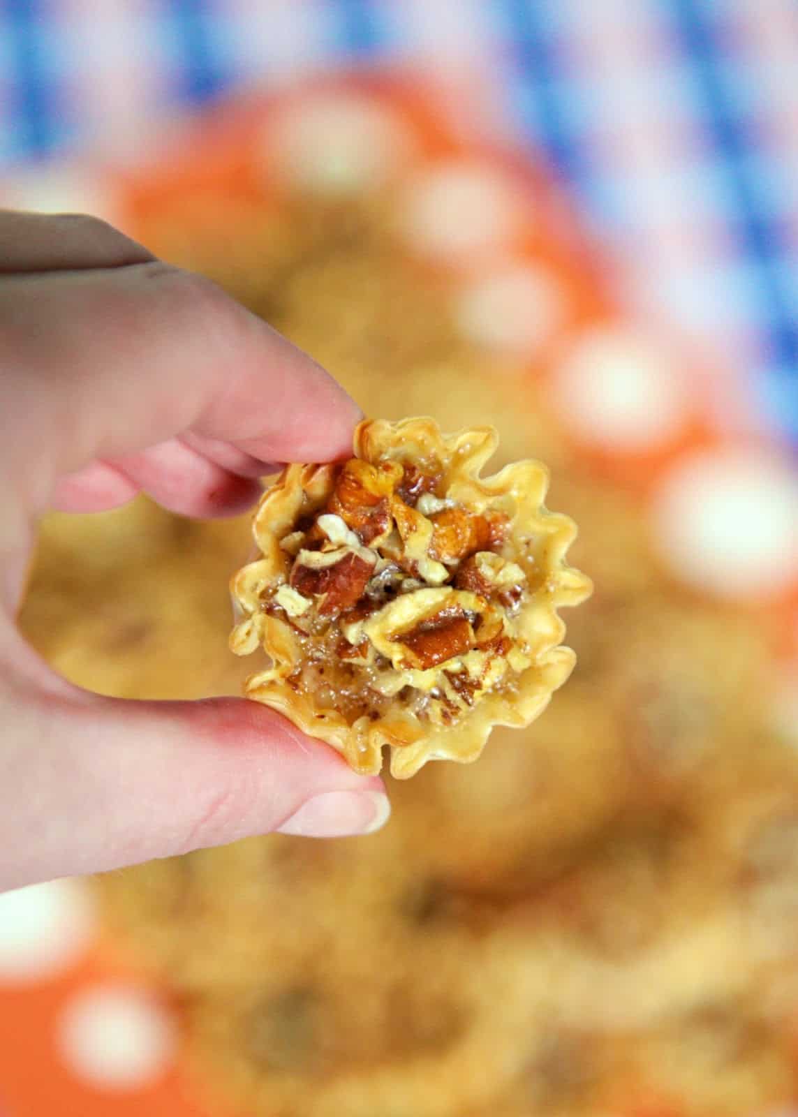 Pecan Pie Bites - pecan pie filling baked in a phyllo shell - great for parties, tailgating or Thanksgiving! Everyone LOVES these bite-sized pecan pie bites! Can make ahead of time and store in an airtight container for several days. Such a great easy dessert recipe!
