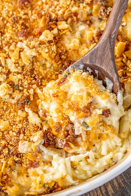 Pepper Jack Potato Casserole - our favorite potato casserole recipe. It is like a cross between traditional potato casserole and scalloped potatoes. LOVE the cheesy bacon cracker crust!!! Frozen shredded hash browns, cream of chicken soup, heavy cream, pepper jack cheese, butter, sour cream, onion powder, garlic powder, ritz crackers, parmesan and bacon. Can make ahead and freeze for later. I always have a batch on hand for a quick and delicious side dish!