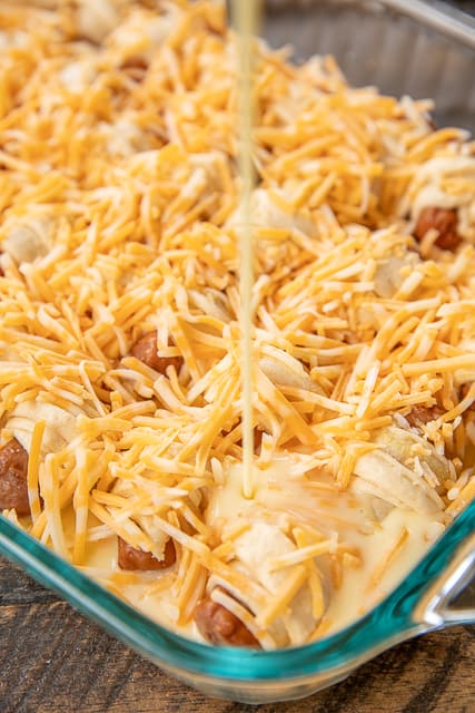 Pigs in a Blanket Breakfast Casserole - seriously the BEST!!! Crescent rolls, dijon mustard, lit'l smokies, cheese, eggs and milk. SO simple and SOOO delicious! Great for breakfast, brunch, lunch, dinner and tailgating! I mean, nothing says football food like pigs in a blanket. Everyone LOVED this easy breakfast casserole. They cleaned their plate and asked for seconds. Success!!! #breakfast #casserole #pigsinablanket #breakfastcasserole