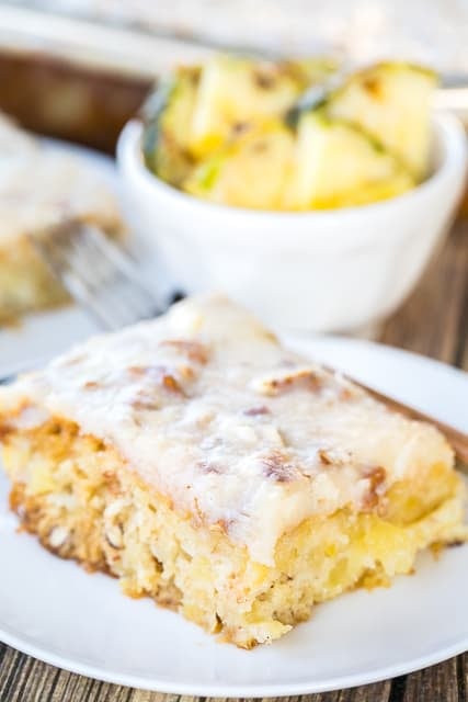 Pineapple Sheet Cake - seriously delicious! Easy pineapple cake with a delicious cream cheese frosting! Sugar, flour, baking soda, vanilla, crushed pineapple, pecans, butter, cream cheese. Great for cookouts and potlucks. Can make ahead of time and refrigerate until ready to serve.