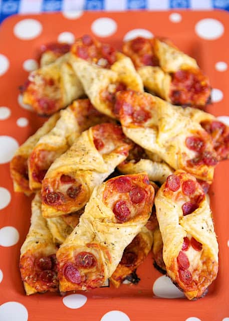 Pepperoni Pizza Pastry Puffs - two bite pizza! Only 5 ingredients and ready in 15 minutes! Perfect for parties and tailgating. We also like to eat these for a quick lunch. Whenever I take these to a party, there are never any left!! Can assemble and freeze for later.