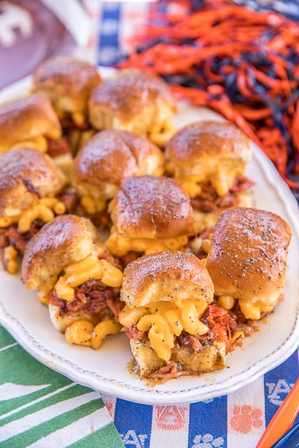 Pulled Pork Mac and Cheese Sliders recipe - CRAZY good! I took these to a party and they were gone in a blink of an eye!!! Slow cooked pulled pork on Hawaiian rolls topped with macaroni and cheese, bbq sauce and a sweet and savory butter sauce. These sandwiches are THE BEST!!!! Pulled pork, store-bought mac and cheese, Hawaiian rolls, bbq sauce, butter, brown sugar, dijon mustard, Worcestershire sauce and poppy seeds. YUM! #pulledpork #ohpork #sandwiches #macandcheese