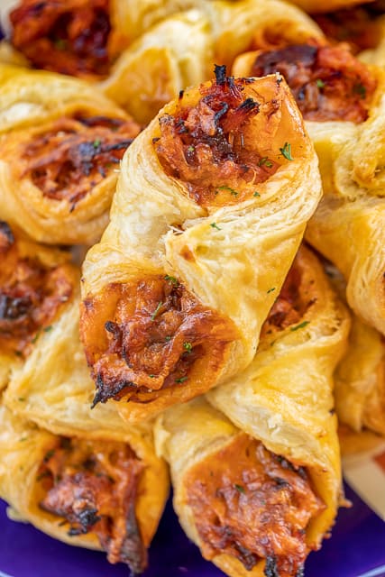 Pulled Pork Pastry Puffs - only 4 ingredients! Great recipe for a quick lunch, dinner or party. Smoky pulled pork tossed with BBQ sauce and cheese then baked in puff pastry. SO good! Can make ahead and freeze for later. We love to serve these with some coleslaw and extra BBQ sauce or Ranch for dipping. YUM! #pulledpork #partyfood #appetizer #tailgating
