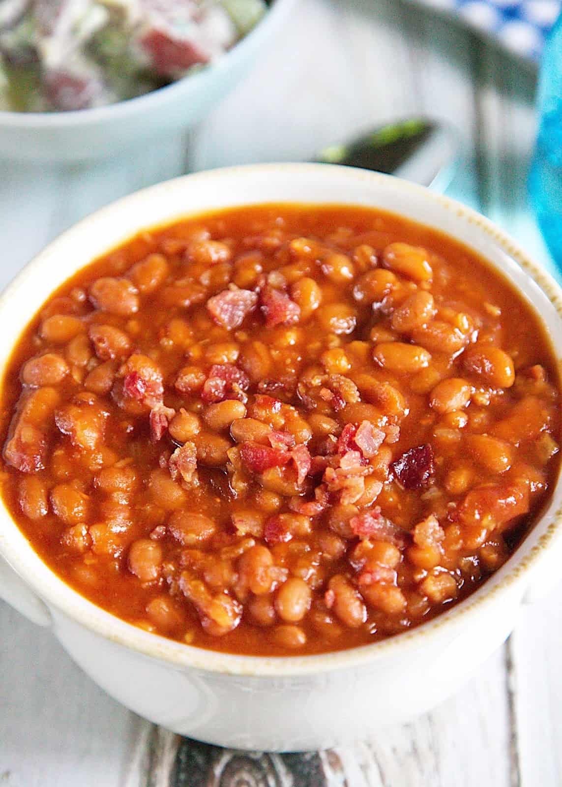 Quick Baked Beans Recipe - Pork and Beans, ketchup, mustard, onions, brown sugar and bacon. Just dump everything in a pan, bring to a boil and then simmer for 10 minutes. SO easy! They also tasted great! I thought they were some of the best we've made. 
