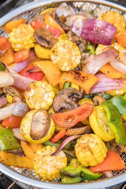 Roasted Garlic Grilled Vegetables - great as a side dish or tossed in pasta. Such an EASY side dish!! Bell peppers, onion, mushrooms, corn and squash tossed in olive oil, brown sugar, paprika, chili powder, salt, pepper and garlic. Ready to eat in about 15 minutes! #grilling #vegetables #sidedish #easysidedish #healthysidedish #lowcarb