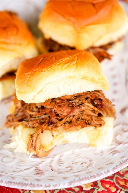 Slow Cooker Teriyaki Pulled Pork - THE BEST pulled pork!! Pork shoulder slow cooked with onions, worcestershire sauce, teriyaki sauce and water. I ate this for a week! SO good!! Serve on Hawaiian Rolls with provolone cheese for parties. Can assemble ahead of time and reheat when ready to serve.