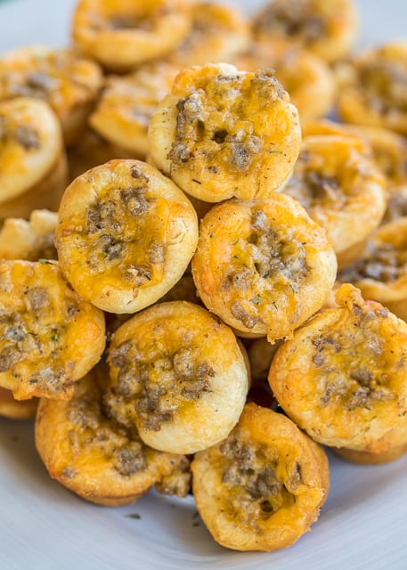 Sausage and Ranch Biscuit Bites - so GOOD! I'm totally addicted to these things! Sausage, ranch dressing, and cheddar cheese baked in biscuits. Can make the sausage mixture ahead of time and refrigerate until ready to bake. Great for tailgating, breakfast and parties! Everyone loves this recipe! #tailgating #tailgatingrecipe #appetizersforacrowd #appetizerrecipe #sausagerecipe #breakfastrecipe #breakfast #partyfood #appetizers #tailgating #ranchdressing